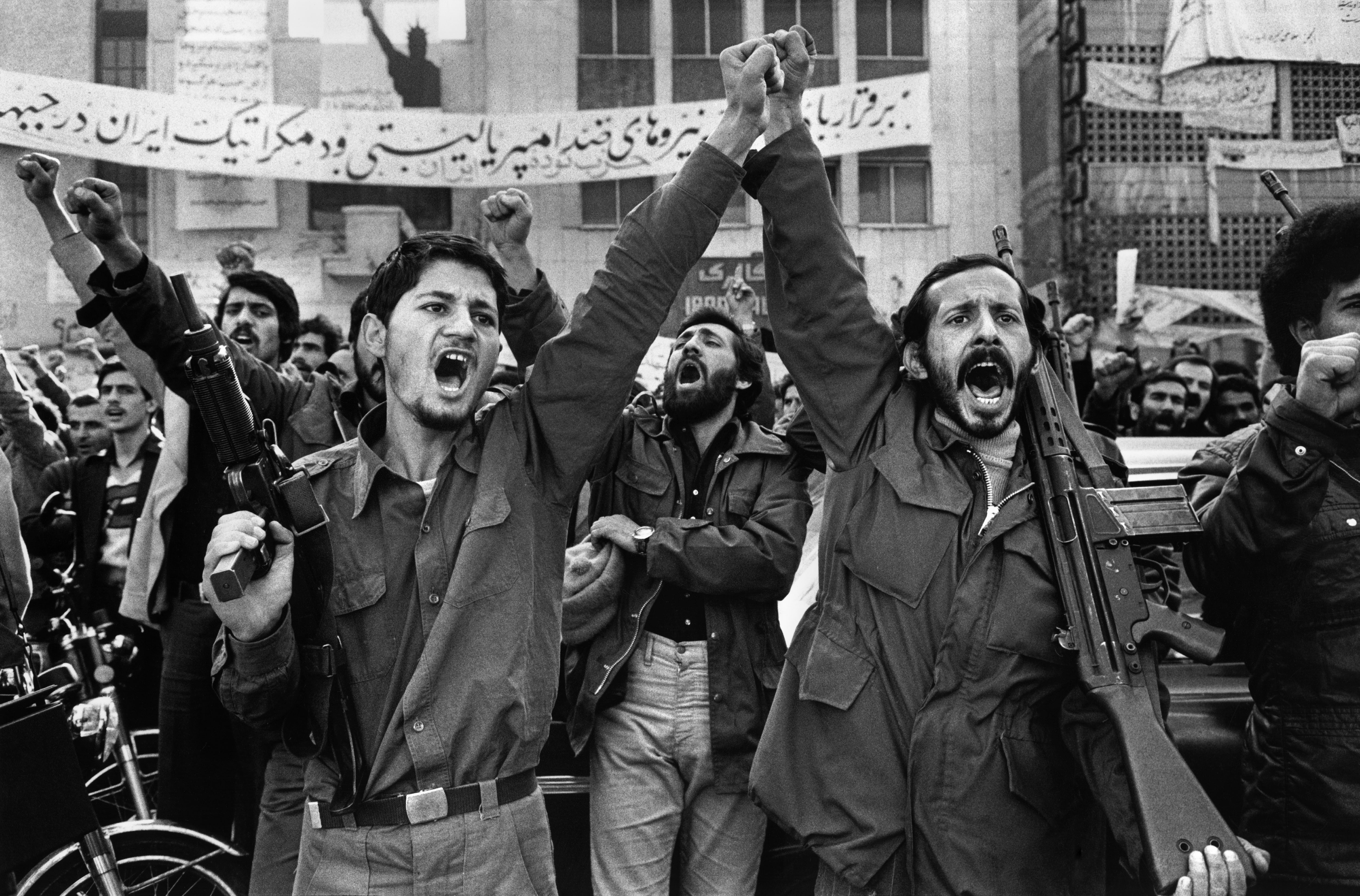 IRAN. Tehran. Armed militants outside the United States Embassy, where diplomats are held hostage since Nov. 4th, 1979. In the background is a banner with the American Statue of Liberty.
